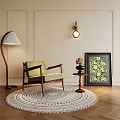 Accent Chair Featuring Floor Lamp Side Table Potted Flowers and Decorative Painting on Light-Colored Wall