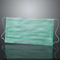 Green Three Layer Face Mask With Ear Loops Featuring Reflection On Black Background