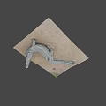 Realistic Crocodile Sculpture Lying On Sandy Surface With Detailed Textured Skin