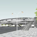 Circular Bridge Over Urban Road Intersection With Greenery And Traffic Lanes