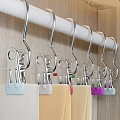 Metal Hooks Hanging On White Rod With Colored Balls Against Wooden Background