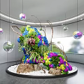 Garden Art Installation with Colorful Flowers Stones White Pebbles Hanging Spheres in Modern Indoor Space