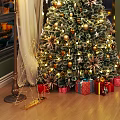 Decorated Christmas Tree With Ornaments Fairy Lights And Gift Boxes In Living Room