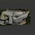 Broken Stone Sculpture With Wooden Base And Natural Grass Surroundings