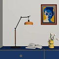 Adjustable Desk Lamp with Orange Shade on Blue Cabinet Open Book Yellow Vase Wall Painting