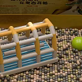 Colorful Playground Equipment With Yellow White Frame Blue Base And Multicolored Balls