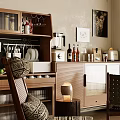Modern Dining Kitchen Area With Cabinets Wine Bottles Coffee Machine And Decorative Paintings