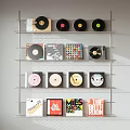 Stylish Headphones and Speakers Display with Colorful Vinyl Records on Wall Shelves