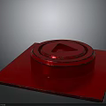 Red Metallic Equipment Component With Square Base Circular Top And Triangular Symbol