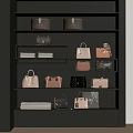 Various Stylish Bags And Boxes Displayed On Black Shelves With Folded Fabrics