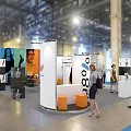 Modern Exhibition Booth Design With Modular White Orange Panels And Interactive Visitor Areas