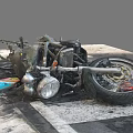 Wrecked Motorcycle With Scorched Parts And Broken Wheel On Zebra Crossing
