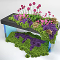 Decorative Floral Installation With Green Purple Moss Pink Flowers On Black Platform And Blue Supports