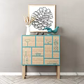 Stylish Entryway Console Cabinet With Turquoise Trim Wooden Legs Panel Line Art And Decorative Figurines