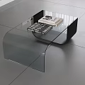 Modern Glass Coffee Table With Black Frame And Books On Gray Tiled Floor