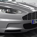 Silver Sports Car Parked In Indoor Space With White Walls Metal Roof And Tire Tracks