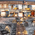 Traditional Town Scenery with Red Roofed Buildings Wooden Balconies Stone Paths Vintage Wheelbarrows and Barrels