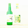 Two Green Transparent Wine Bottles With Champagne Dewdrop And Calamansi Fruit Flavors Bilingual Labels