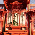 Traditional Chinese Red Garden Ornament With Carved Pavilion Structure And Green Plants