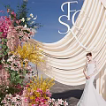 Wedding Photo Spot With Beige Drape Floral Decor And Bride In White Dress