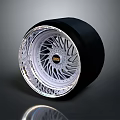 Shiny Black Tire With Modern Silver Alloy Rim And Intricate Spoke Pattern