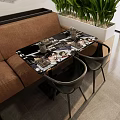 Modern Restaurant Interior With Tables Chairs Green Plants And Black White Decorative Paintings