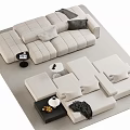 Modern Cream Colored Modular Sectional Sofa With Pillows And Coffee Tables In Living Room Setup