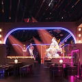 Modern Bar Interior with Neon Lights Sculpture Colorful Lighting and Seating Area