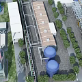Aerial View Of Industrial Factory With Large Buildings Blue Storage Tanks And Greenery