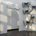 Beige Arched Storefront With Wooden Plaque and Multiple Colored Bows Green Blue Gold Gray Silver