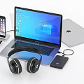 Modern Laptop Setup With Smartphone Headphones External Hard Drive And Charging Cable