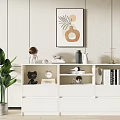 Stylish White Cabinet with Black Bear Figurine Clock Books and Green Plant Near Wall Painting