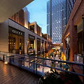 Bustling Modern Commercial Street Plaza With Illuminated Buildings Shops And Pedestrians