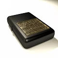 Classic Black Metal Lighter With Golden Engraved Pattern And Sleek Design