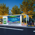 Modern Roadside Bus Stop Shelter with Screen Display and Green Trees