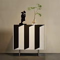 Modern Entryway Cabinet Sideboard with Black White Striped Design Metal Legs Decorative Figurine and Green Plant