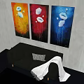 Black Double Sofa With Striped Cushion White Blanket And Three Floral Paintings On Gray Wall