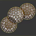 Three Honeycomb Patterned Spheres With Golden Frames And Transparent Interior On Reflective Surface