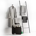 Bathroom Accessories Featuring Grey Bathrobe On Wooden Hanger And Textured Towels On Black Metal Rack