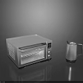 Sleek Modern Stainless Steel Kitchen Appliances Featuring Toaster Oven And Kettle On Black Reflective Surface