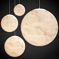 Round Cream Colored Pendant Lights With Moon Surface Texture Hanging In Modern Interior