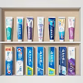 Colorful Toothpaste Display Set With Tubes And Boxes Arranged On Shelf