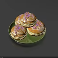 Three Freshly Baked Muffins on Green Plate with White Icing and Purple Sprinkles