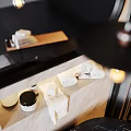 Modern Bathroom Accessories With Pump Bottles Stacked Towels And Marble Backdrop