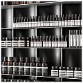 Neatly Arranged Perfumes And Cosmetics Display On Multiple Shelves With Various Bottles And Different Colors