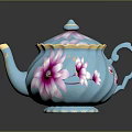 Blue Teapot With Pink Floral Patterns And Gold Accents On Lid And Handle