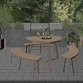 Outdoor Patio Table and Bench Set with Green Plants and Grill in Garden