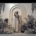 Golden Archway Photo Check-in Spot With Woman In Brown Dress And Orange Plants