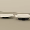 Two White Ceramic Dishes With Black Bases On Light Surface Minimalist Design