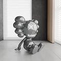 Metallic X Eyed Modern Doll In Minimalist Indoor Setting With Gray Wall And Blinds